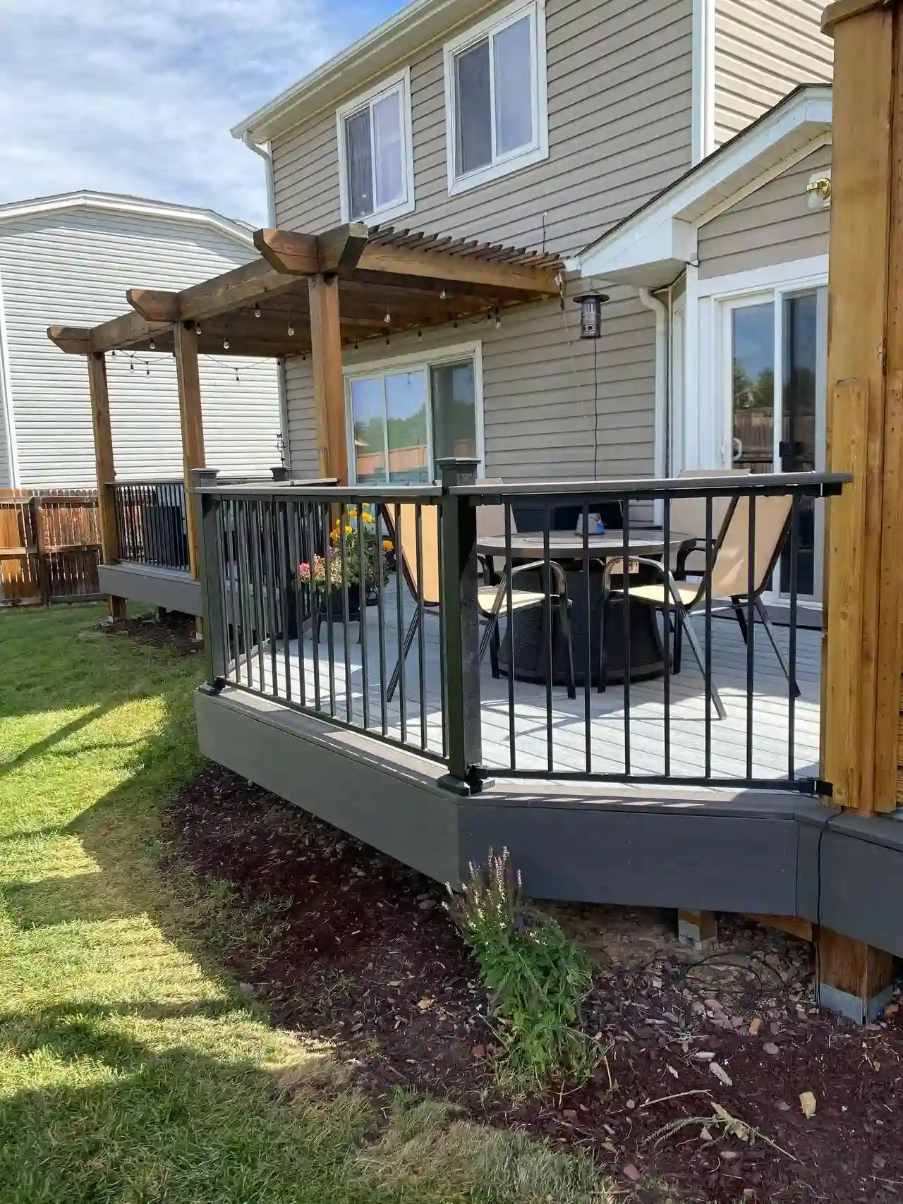 Composite deck with stairs beside a home