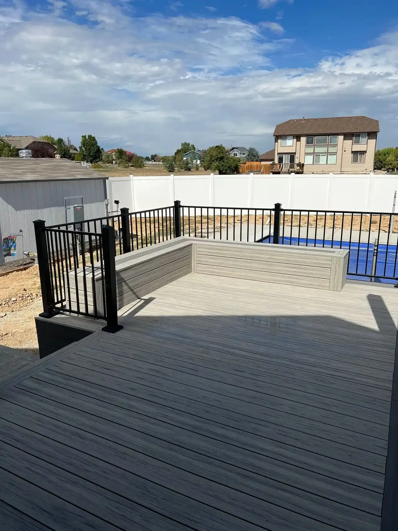 Large composite deck overlooking a pool