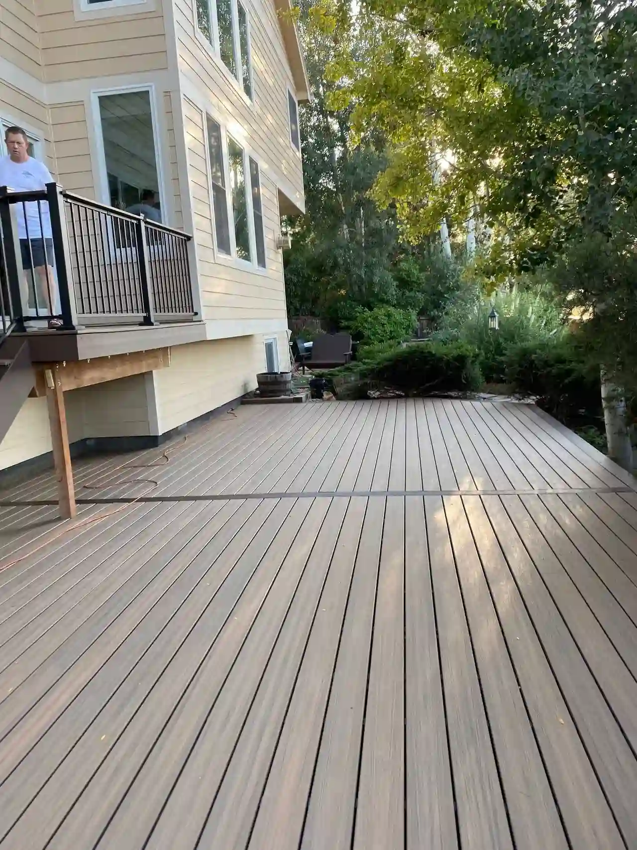Long composite deck walkway beside a home